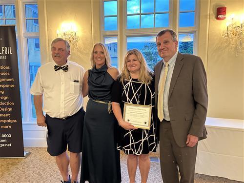 Pictured left to right - NHSAA Scholarship Chair -  Dr. Dean Cascadden, SAU 58 Superintendent - Dr. Ronna HasBrouck, Michelle Overhoff, NHSAA Acting Executive Director - Jerry Frew