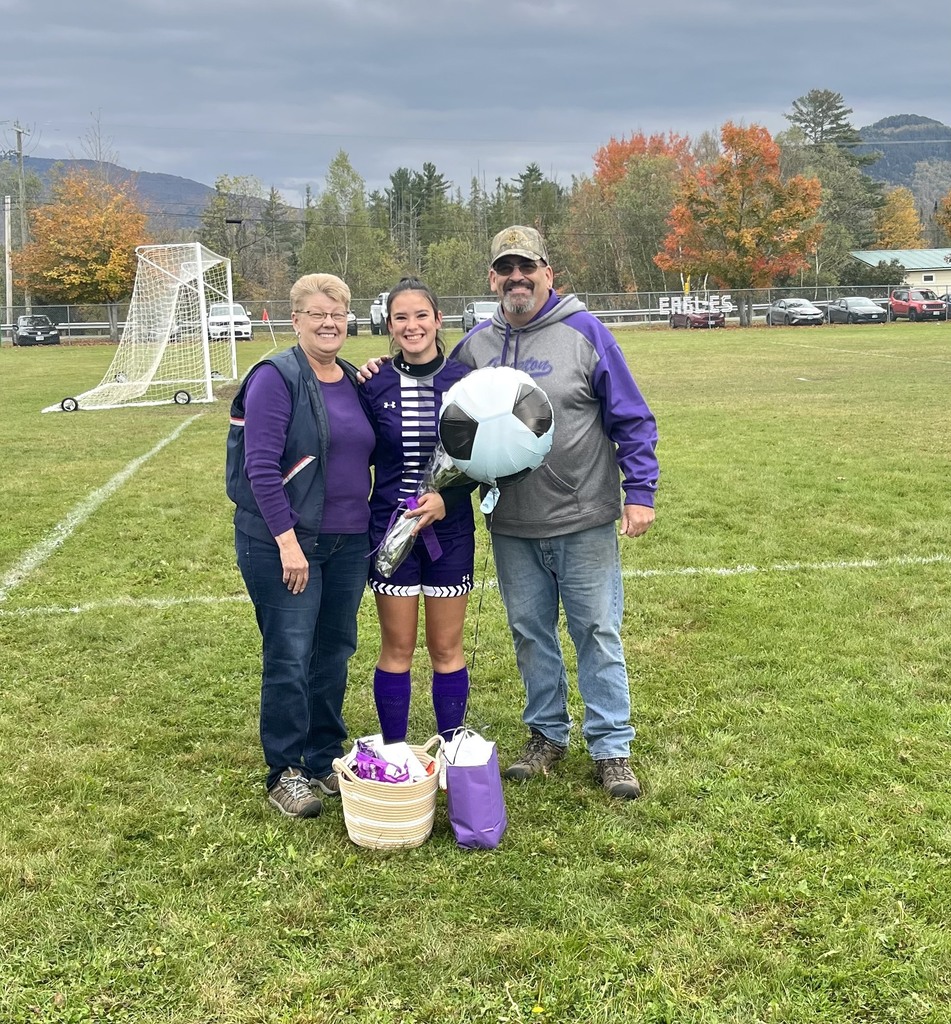 Family of three standing with their senior soccer player